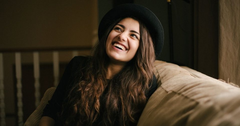 girl sitting on couch smiling